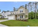 A charming two-story home featuring a two-car garage and manicured landscaping at 1216 Dimaggio Dr # 29, Raleigh, NC 27616