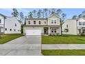 Charming two-story home with a two-car garage, a well-kept lawn, and a welcoming front porch at 1216 Dimaggio Dr # 29, Raleigh, NC 27616