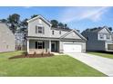 Two-story home featuring a two-car garage, manicured lawn, and neutral siding at 1221 Dimaggio Dr # 10, Raleigh, NC 27616