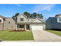 Two-story home featuring a two-car garage, manicured lawn, and neutral siding at 1221 Dimaggio Dr # 10, Raleigh, NC 27616