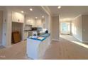 Open-concept kitchen featuring white cabinetry, modern fixtures, and a convenient center island at 1665 S Old Carriage Rd, Rocky Mount, NC 27804