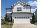 Charming two-story home featuring a two-car garage, light gray siding, and well-maintained landscaping at 2117 Attend Xing, Fuquay Varina, NC 27526