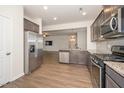 Spacious kitchen featuring stainless steel appliances and hardwood floors at 2117 Attend Xing, Fuquay Varina, NC 27526