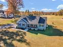 Expansive aerial view of a well-maintained home with a sprawling lawn at 3217 Satterwhite Point Rd, Henderson, NC 27537