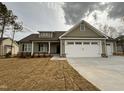 Charming one-story home featuring a two-car garage, stone accents, and manicured lawn at 102 Roma Gora Ct, Princeton, NC 27569
