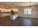Modern kitchen featuring white cabinets, stainless steel appliances, and an island for extra prep space at 103 Roma Gora Ct, Princeton, NC 27569