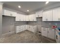 The spacious kitchen is equipped with white cabinets, and ample counter space at 103 Roma Gora Ct, Princeton, NC 27569