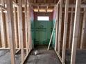 Framed bathroom area with visible studs and a protective green barrier, highlighting the plumbing layout at 104 Roma Gora Ct, Princeton, NC 27569