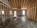 Framed living room featuring stud walls, exposed ceiling beams, and space for built-in shelves at 106 Roma Gora Ct, Princeton, NC 27569