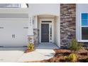 Inviting front entrance with stone detailing and a charming porch at 1221 Cricket St, Elon, NC 27244