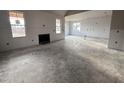 Spacious living room featuring a fireplace and large windows at 141 Ruskin Dr, Smithfield, NC 27577