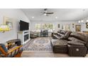 Living room with sectional sofa, fireplace, and large TV at 34 Mcintosh Ct, Fuquay Varina, NC 27526