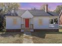 White house with red front door, grey roof and small yard at 619 N Mebane St, Burlington, NC 27217