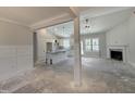 Bright, open-concept living space with fireplace, seamlessly connecting to the modern kitchen at 702 Tuscany Cir, Princeton, NC 27569