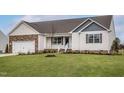 Inviting single-story home with a landscaped front yard and a covered porch entrance at 11320 International Dr, Middlesex, NC 27557