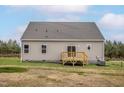 View of the back of house featuring a small wooden deck and vinyl siding at 11360 International Dr, Middlesex, NC 27557