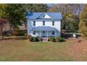 Charming two-story home with a metal roof and a covered porch at 206 Pike Memory Ln, Staley, NC 27355