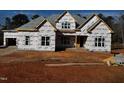 New construction home with architectural shingles and a large front yard at 2408 Toll Mill Ct, Raleigh, NC 27606