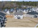 Aerial view of the backyard surrounded by neighboring homes and mature trees in distance at 77 Buckhorn Branch Park # 174, Clayton, NC 27520