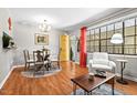 Inviting dining area with a glass table, seating for four, and a view of the front entry at 807 W Trinity Ave # 220, Durham, NC 27701