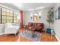 Comfortable living room with a plush armchair, modern rug, and bright window at 807 W Trinity Ave # 220, Durham, NC 27701