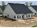 New home backyard featuring a concrete patio, dark roof, and neutral siding at 1060 Fairhaven Dr # 96, Mebane, NC 27302