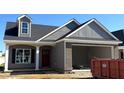 Modern exterior showcasing a two-car garage and attractive architectural details at 180 Brunswick Dr, Nashville, NC 27856