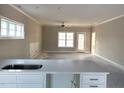 Open-concept living area with neutral walls, a ceiling fan, and ample natural light at 180 Brunswick Dr, Nashville, NC 27856