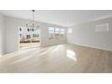 Spacious dining area with hardwood floors and large windows at 20 Nettle Ln # 239, Clayton, NC 27520