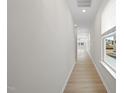 Bright hallway with light hardwood floors and neutral walls at 20 Nettle Ln # 239, Clayton, NC 27520