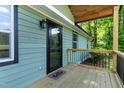 Welcoming porch with a decorative glass front door, a 'hello' mat, and fresh paint at 2704 Ross Rd, Durham, NC 27703