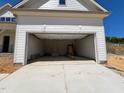 Spacious two car garage ready for your vehicles with a concrete driveway leading to the street at 6040 Scalybark Road, Durham, NC 27712