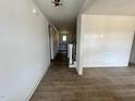 Bright hallway featuring beautiful hardwood floors, wainscoting, and access to staircase at 6040 Scalybark Road, Durham, NC 27712
