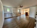Open-concept living room with built-in shelving, a fireplace, and hardwood flooring at 6040 Scalybark Road, Durham, NC 27712