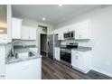 Modern kitchen features stainless steel appliances, granite countertops, and white cabinetry at 286 Yellowwood Ave, Spring Hope, NC 27882