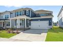 Stylish blue home with a two-car garage, covered entry, and well-maintained front lawn at 441 Edison Rail Ln, Knightdale, NC 27545