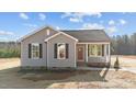Gray exterior of charming one-story home with red door and landscaping at 145 Brookhaven Dr, Spring Hope, NC 27882
