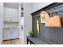 Organized entryway with bench, hooks, and cabinet storage at 149 Brandy Ml, Pittsboro, NC 27312