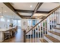 View of a living area and staircase with white railings and hardwood floors at 149 Brandy Ml, Pittsboro, NC 27312