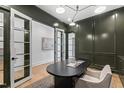 Office with dark green walls, a desk, white trim, and bright light from adjacent room at 2417 Mayview Rd, Raleigh, NC 27607