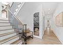 Elegant staircase with wood treads, black railings, and bright, natural light at 2417 Mayview Rd, Raleigh, NC 27607