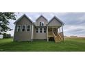 Rear exterior of home with a partially covered porch and a spacious backyard at 294 White Azalea Way, Homesite 74, Benson, NC 27504
