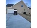 Spacious garage and extended driveway with a golf cart parked nearby at 294 White Azalea Way, Homesite 74, Benson, NC 27504