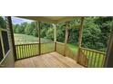 Screened-in porch with wooden flooring and natural views of the outdoor surroundings at 294 White Azalea Way, Homesite 74, Benson, NC 27504