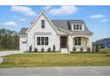 Lovely white brick home with a dark wood front door, two-car garage, well-manicured lawn, and tidy landscaping at 3804 Cobbler View Way, Fuquay Varina, NC 27526