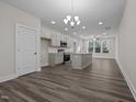 Open concept dining room with hardwood floors and kitchen island at 811 Pryor St, Mebane, NC 27302