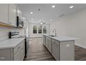 Modern kitchen with gray cabinets, quartz countertops, and stainless steel appliances at 811 Pryor St, Mebane, NC 27302