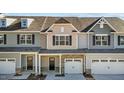 Attractive townhome with light beige and gray siding, and a 2 car garage at 813 Pryor St, Mebane, NC 27302