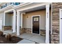 Townhome's front entrance with stone accents and a dark brown door at 813 Pryor St, Mebane, NC 27302