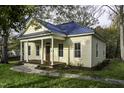 Inviting two-story home with a blue metal roof, charming columns, and a stone walkway at 915 S 3Rd St, Sanford, NC 27330